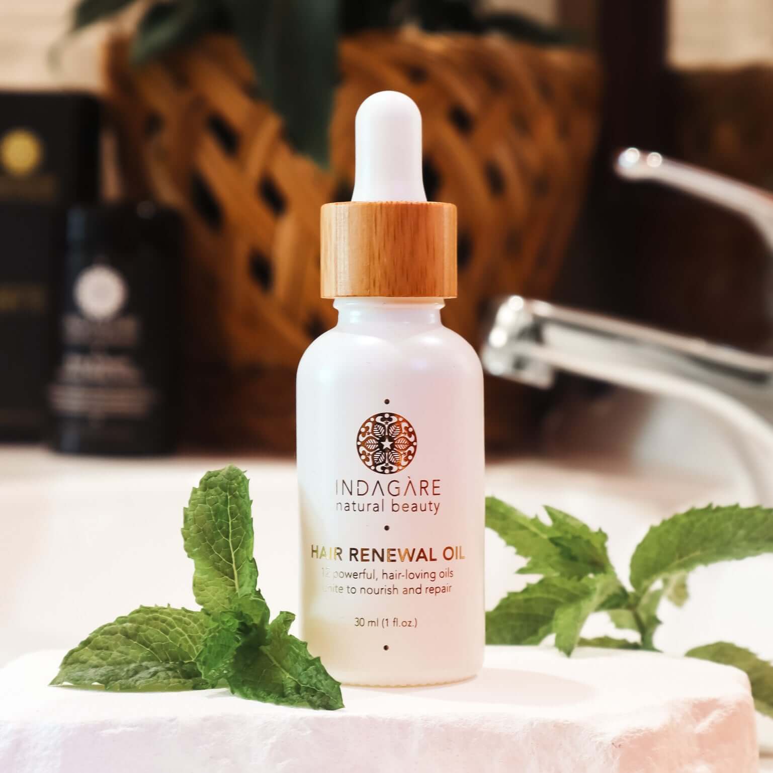 Indagare Organic Hair Renewal Oil sitting on a stylish bathroom vanity