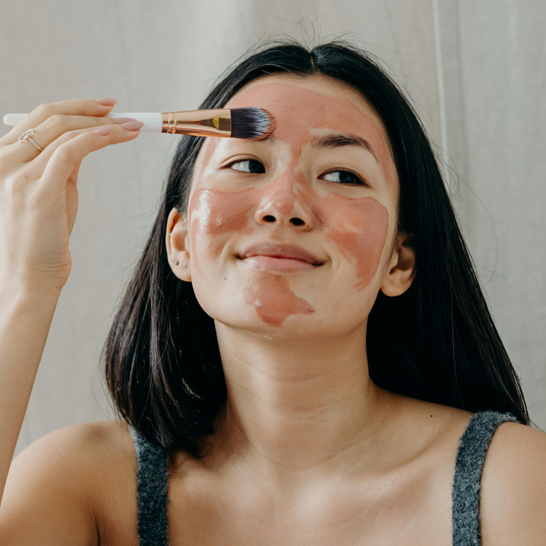 Woman demonstrating using a Natural Skincare face mask