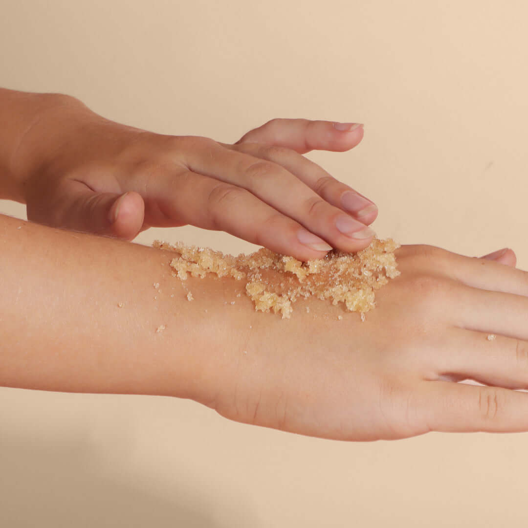 Woman applying Rose and Neroli Luxury Organic Body Scrub to the back of one hand