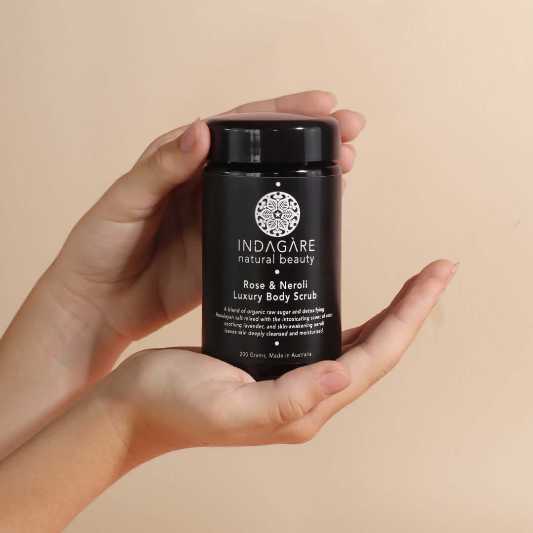 Woman's hands holding a jar of Rose and Neroli Luxury Organic Body Scrub