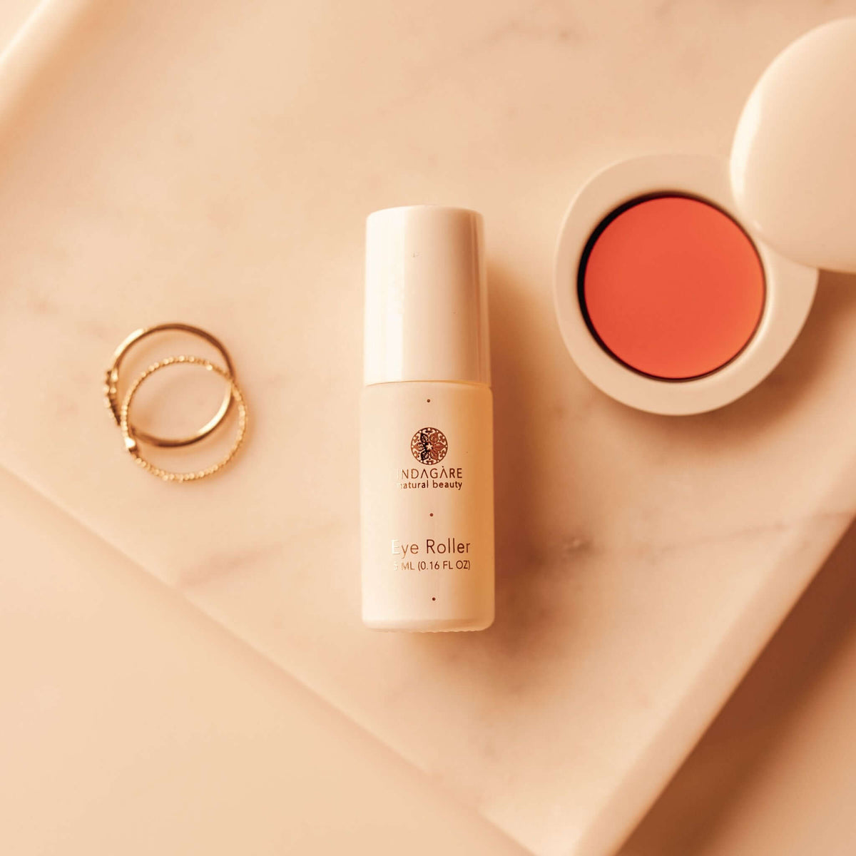 Prickly Pear Seed Oil eye roller displayed on bathroom vanity with makeup