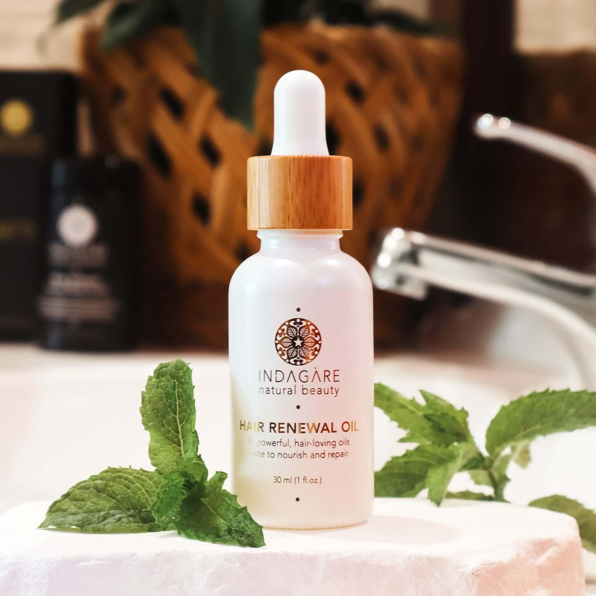 Indagare Organic Hair Renewal Oil sitting on a stylish bathroom vanity